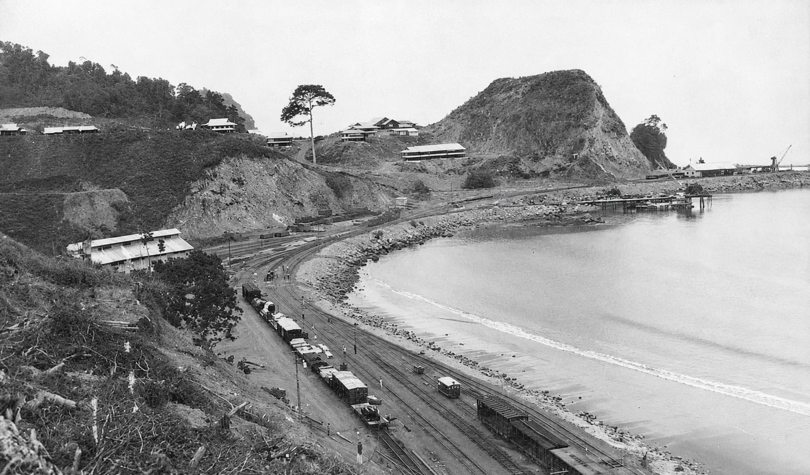 An archive photograph of the bay with railway wagons standing along the shore