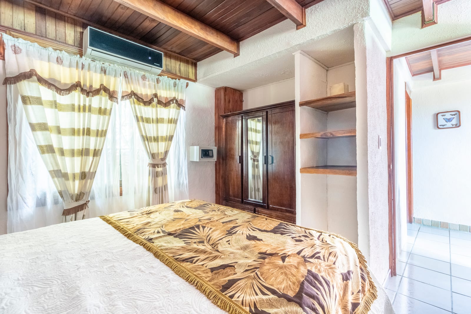 Bougainvillea Suite garden view room with queen bed and kitchenette